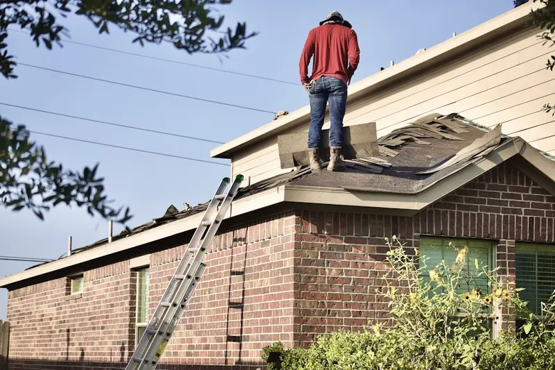 Professional roofer working on a residential roof in Brandywine